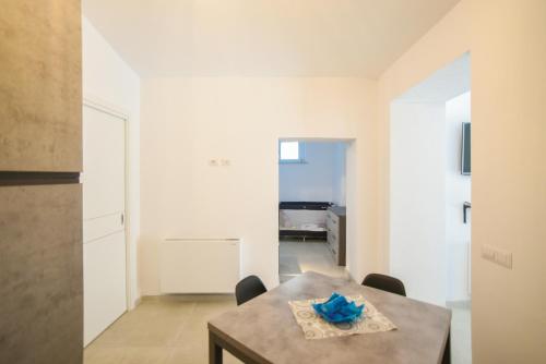 a kitchen and dining room with a table and chairs at Tatta & Nanna Apartment in Oliena