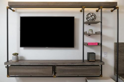 a flat screen tv hanging on a wall at voco The Tuxon by IHG in Tucson