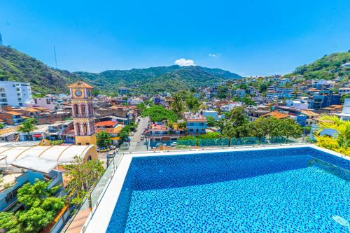 a large swimming pool in the middle of a city at Tres Marias Luxury Suites - Adults Only in Puerto Vallarta