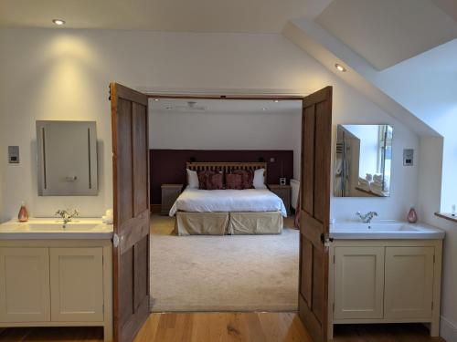 a hotel room with a large bed and a large mirror at Elderbrook House in Avebury