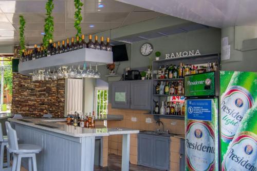 a kitchen with a bar with bottles of alcohol at Hotel Plaza Europa in Sosúa