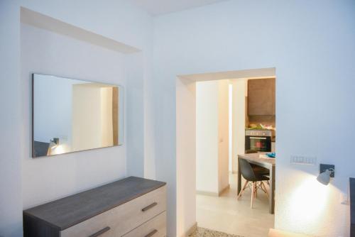 a living room with a mirror on the wall at Tatta & Nanna Apartment in Oliena