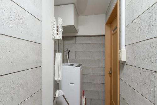 a small kitchen with a washer and dryer in a room at I Planet Nanba - Vacation STAY 8480 in Osaka