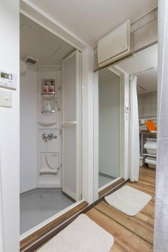 a small bathroom with a shower and white walls at I Planet Nanba - Vacation STAY 8480 in Osaka