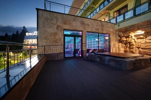 a balcony of a building with a view of the city at Hotel Pegaz in Krynica Zdrój
