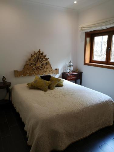 a bedroom with a large bed with two pillows at Encosta do Douro - Rio Douro in Cinfães