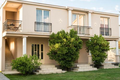 a house with trees in front of it at Studio Apartment Vukcevic in Podgorica