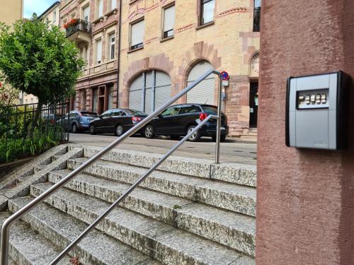 a set of stairs with cars parked on a street at Kamus in Baden-Baden