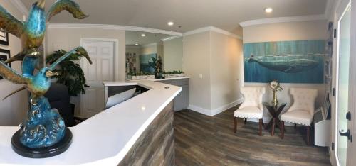 a living room with a large painting of a whale at Estero Inn in Morro Bay