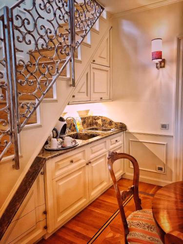 a kitchen with a sink and a wooden table at Relais Colle San Pietro in Verona
