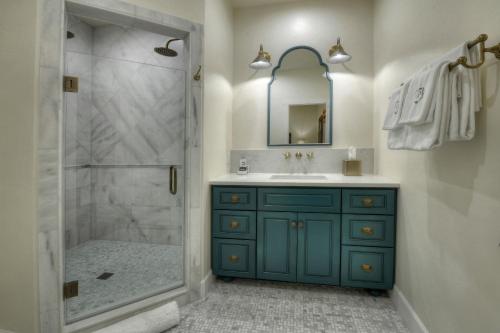 a bathroom with a blue cabinet and a shower at Armory Park Inn in Tucson