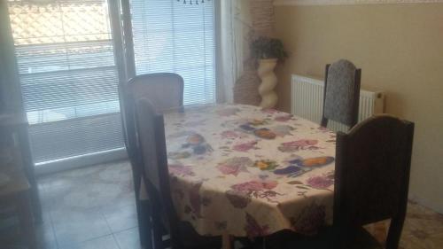 a table and chairs with a floral table cloth on it at Apartmány Agi a Milan in Spišská Nová Ves