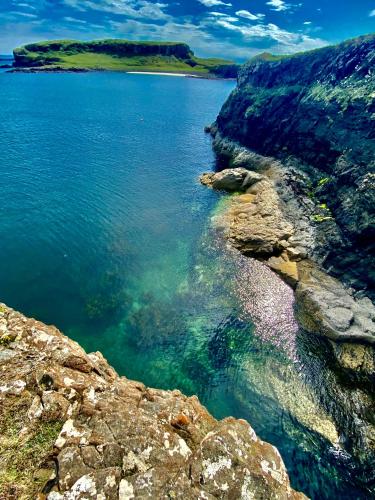 a large body of water next to a rocky shore at The Lodge Dunrowan in Kyle of Lochalsh