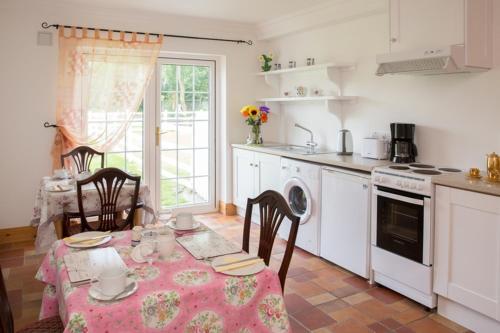 a kitchen with a table with a table cloth on it at Shannon Breeze B&B in Killaloe