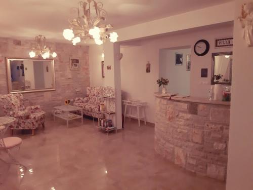 a living room with couches and a stone wall at Villa Claudia in Fažana