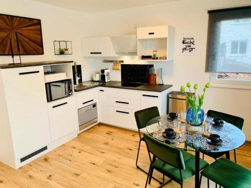 a kitchen with a table and chairs in a room at Lessinghaus in Pforzheim