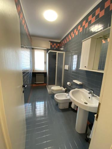 a bathroom with two toilets and a sink at Sky Garden & Wellness R. in Belluno