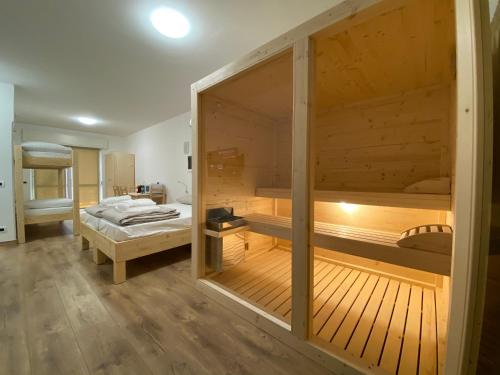 a room with a bed and a large wooden room with a bed sqor at Sky Garden & Wellness R. in Belluno