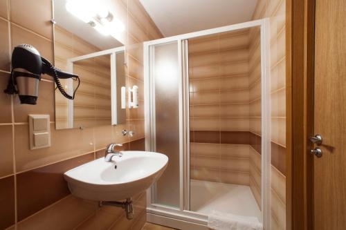 a bathroom with a sink and a shower at Dzintars Hotel in Jūrmala