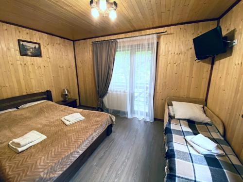 Ένα ή περισσότερα κρεβάτια σε δωμάτιο στο Під Магурою