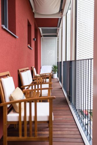 a row of chairs and tables on a balcony at Koper Seaside Residence in Koper