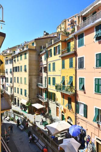 a group of buildings with umbrellas in a city at CATEO in Riomaggiore
