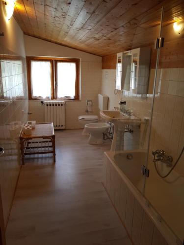 a bathroom with two sinks a toilet and a shower at Appartamenti Bice Abetone in Abetone
