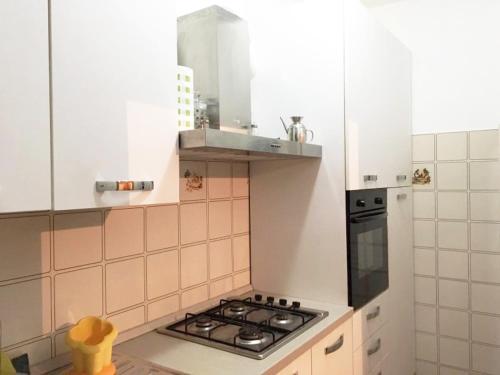 a kitchen with a stove top oven in a kitchen at La Collina di Emma in Massignano