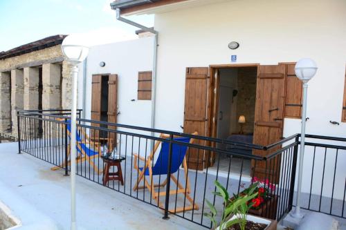 a balcony of a house with a blue chair at Lazaros Stonehouse in Pano Lefkara