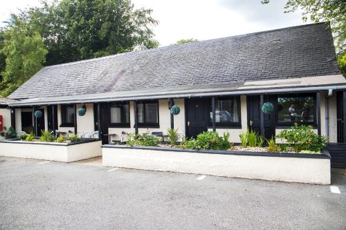 a house with plants in the windows of it at Ardennan House Hotel in Inverurie