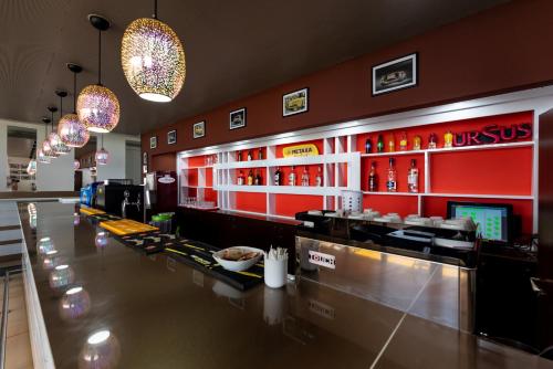 a bar in a restaurant with red walls at Hotel Capitol in Jupiter