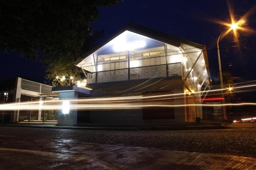 a house at night with a car driving past it at Orange Mangrove Pension House by SMS Hospitality in Puerto Princesa City