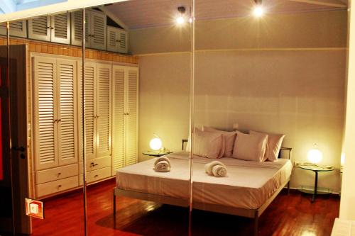 a bedroom with a bed with two towels on it at Vallia Suites - Luxury Penthouse in Nafpaktos