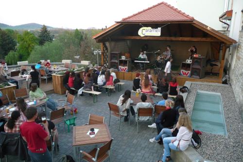 a group of people sitting at tables in a building at Caramell in Louny