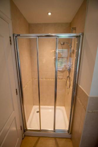 a shower with a glass door in a bathroom at Inchmarlo Golf Resort, Banchory Villa 26 AS 00266F in Banchory