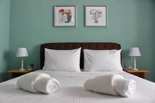 a bedroom with a bed with towels on it at Vallia Suites - Double suite B1 in Nafpaktos