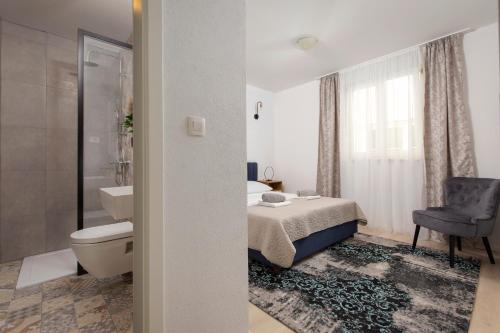 a bathroom with a bed and a toilet and a sink at Apartment Antoni 2 in Podstrana