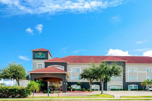 a hotel with a clock tower on top of it at La Quinta by Wyndham Mission at West McAllen in Mission