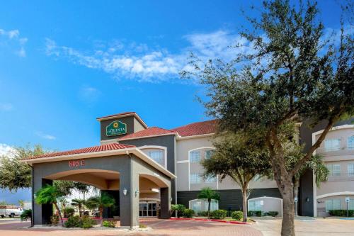a hotel building with a clock on top of it at La Quinta by Wyndham Mission at West McAllen in Mission