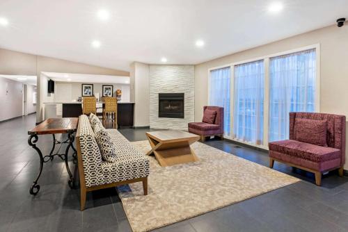 a living room with two chairs and a table at La Quinta Inn by Wyndham Caldwell in Caldwell