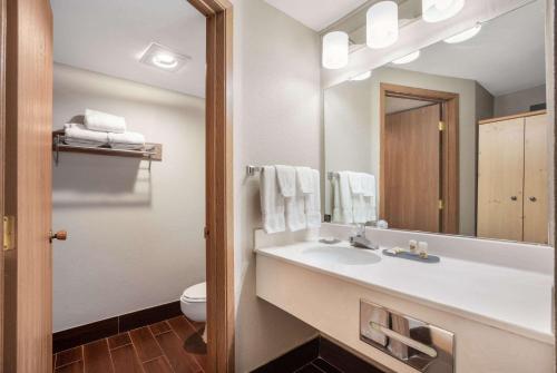 a bathroom with a sink and a mirror at La Quinta Inn by Wyndham Caldwell in Caldwell