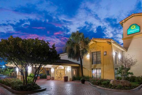 a hotel with a palm tree in front of a building at La Quinta Inn by Wyndham San Antonio Market Square in San Antonio