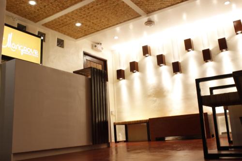 a lobby with a waiting room with a sign on the wall at Orange Mangrove Pension House by SMS Hospitality in Puerto Princesa City