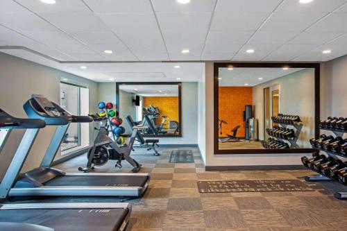 a gym with cardio equipment and a large mirror at La Quinta by Wyndham San Francisco Airport North - Free Airport Shuttle in South San Francisco