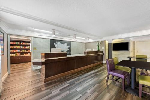 a lobby with a reception desk and a table and chairs at La Quinta Inn by Wyndham Miami Airport North in Miami