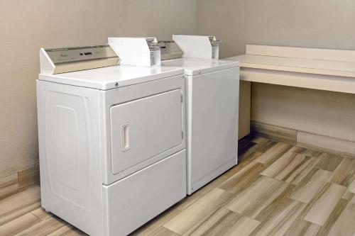 a white washer and dryer sitting next to a counter at La Quinta by Wyndham Birmingham Hoover in Hoover