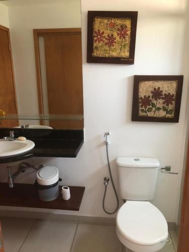 a bathroom with a toilet and a sink and a mirror at Fleixeiras Eco Residence in Trairi