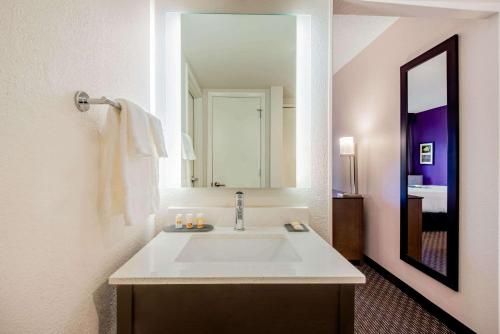 a bathroom with a sink and a large mirror at La Quinta by Wyndham Baltimore BWI Airport in Linthicum Heights