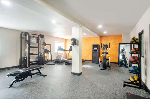 a gym with several exercise equipment in a room at La Quinta Inn by Wyndham St. Louis Hazelwood - Airport North in Hazelwood