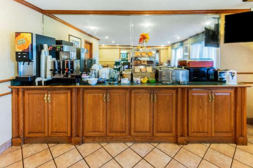 a kitchen with wooden cabinets and a counter top at La Quinta Inn & Suites by Wyndham Las Cruces Organ Mountain in Las Cruces